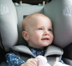 Baby correctly seated in a rear-facing car seat